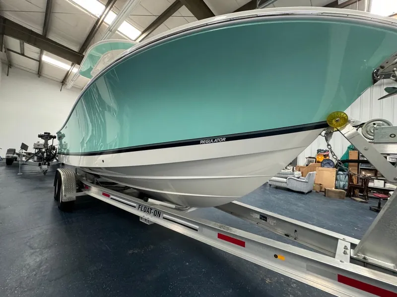 Slide: The Image of 2022 Regulator 25 boat on trailer in indoor storage facility. - 43