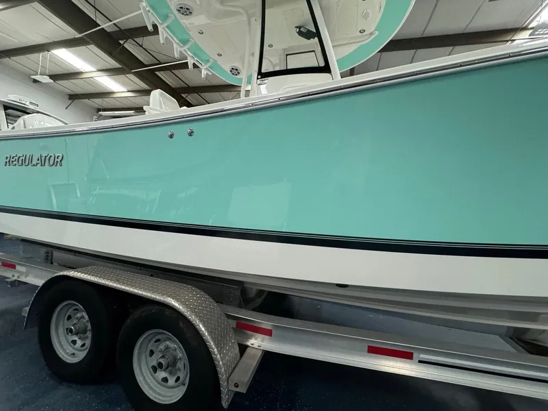 Slide: The Image of 2022 Regulator 25 boat on trailer in indoor showroom. - 44