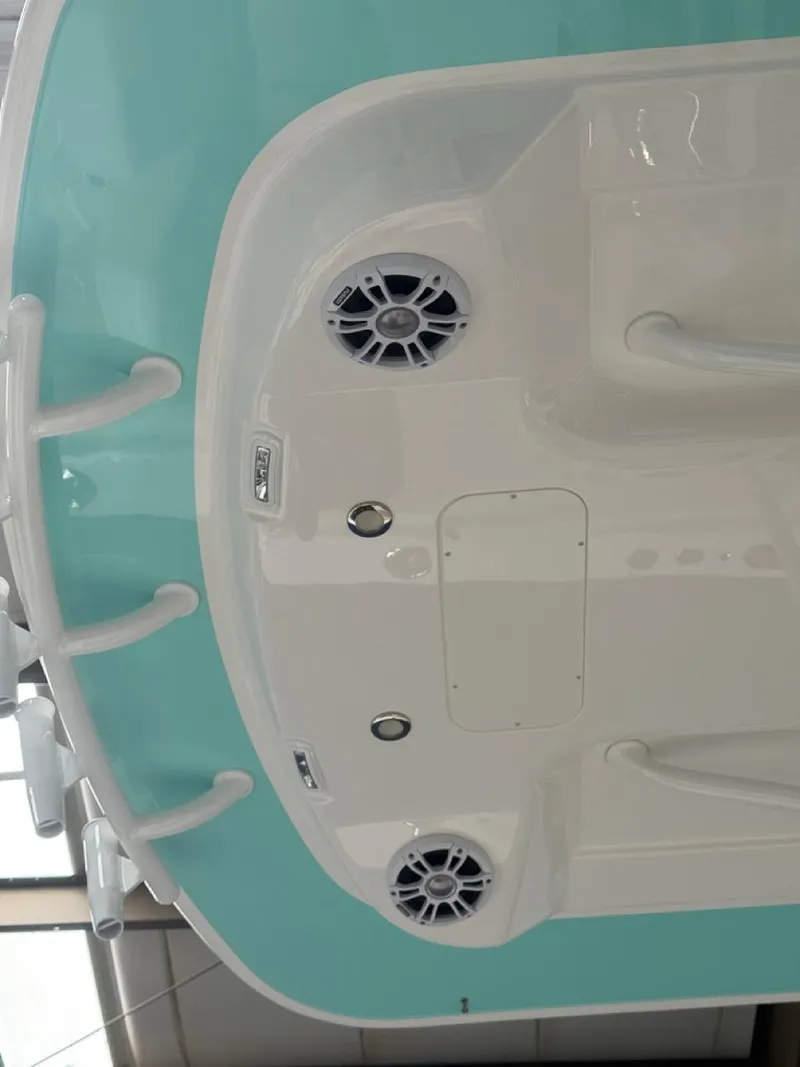Slide: The Image of 2022 Regulator 25 boat deck with teal accents and built-in speakers. - 46