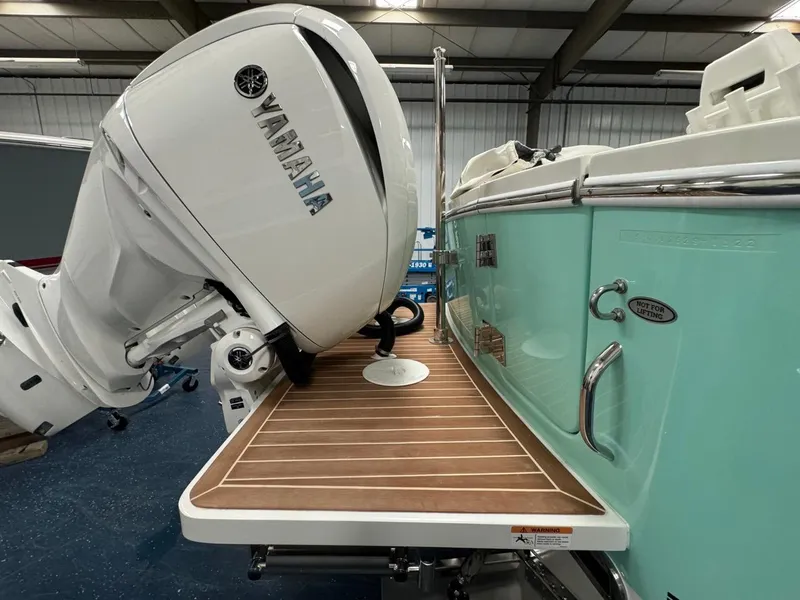 Slide: The Image of 2022 Regulator 25 boat with Yamaha outboard motor and teak swim platform. - 47