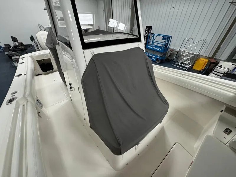 Slide: The Image of 2022 Regulator 25 boat interior with covered console in a showroom. - 6