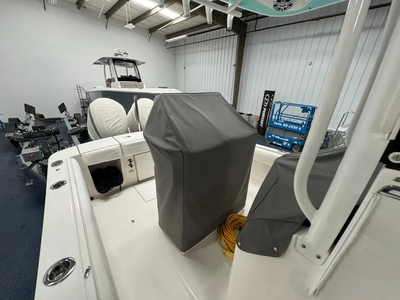 Slide: The Image of 2022 Regulator 25 boat interior in showroom with covered console and equipment. - 7