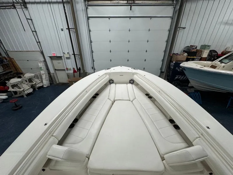 Slide: The Image of 2022 Regulator 25 boat interior with white seating in a storage facility. - 9