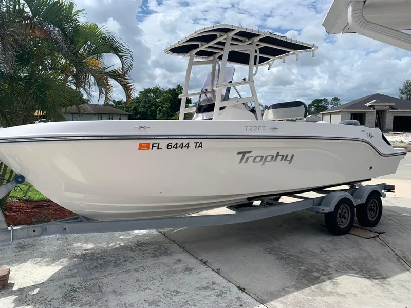 Slide: The Image of 2021 Trophy T22 boat on trailer, parked outdoors, with Florida registration. - 1