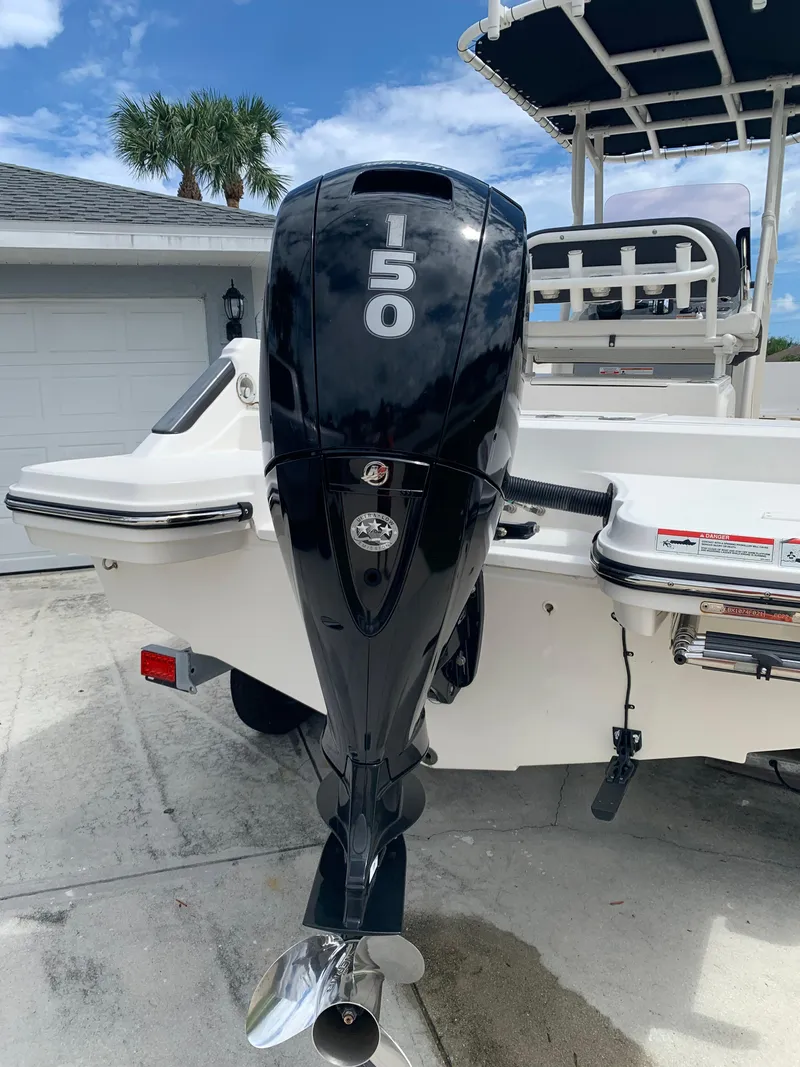 Slide: The Image of Trophy T22 boat with 150 horsepower outboard motor, parked in driveway. - 4