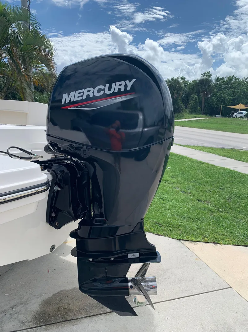 Slide: The Image of Mercury outboard motor on 2021 Trophy T22 boat, parked outdoors. - 5