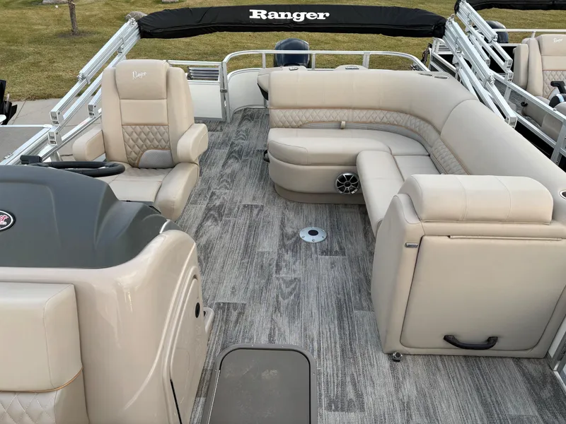 Slide: The Image of 2024 Ranger Reata 223FC boat interior with beige seating and modern design. - 10