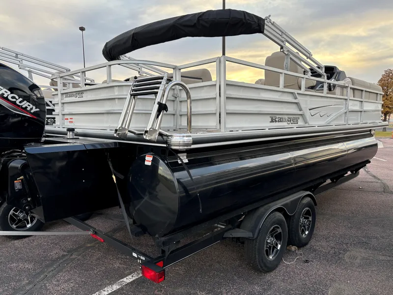 Slide: The Image of 2024 Ranger Reata 223FC pontoon boat on trailer, featuring sleek design and dual Mercury engines. - 2