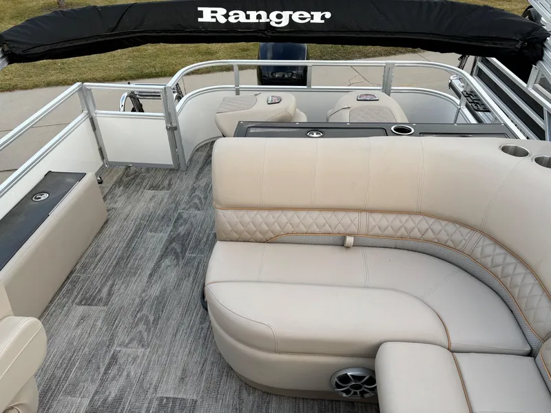 Slide: The Image of 2024 Ranger Reata 223FC pontoon boat with beige seating and sleek interior design. - 9