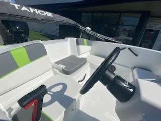 Slide: The Image of 2024 Tahoe T16 boat interior with steering wheel and seating. - 11