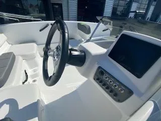 Slide: The Image of 2024 Tahoe T16 boat dashboard with steering wheel and control panel. - 12