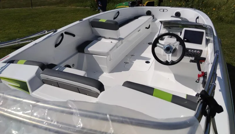 Slide: The Image of 2024 Tahoe T18 boat interior with modern seating and steering console. - 5