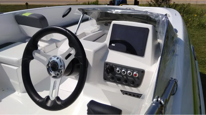 Slide: The Image of 2024 Tahoe T18 boat dashboard with steering wheel and control panel. - 6
