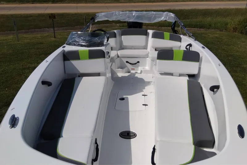 Slide: The Image of 2024 Tahoe T18 boat interior with white and green seating, spacious layout. - 8