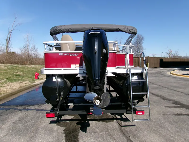 Slide: The Image of 2024 Ranger Reata 200F pontoon boat with outboard motor, parked on a sunny day. - 3