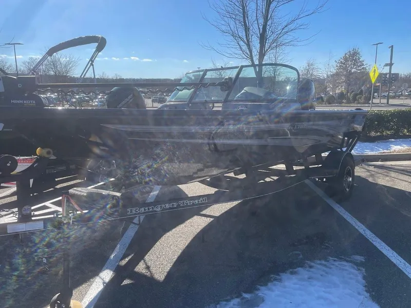The Image of 2024 Ranger VS1782SC Angler boat on trailer in parking lot, sunny day. - 0