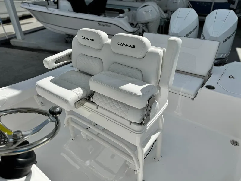 Slide: The Image of 2025 Caymas 281 HB boat with dual cushioned seats and steering wheel. - 10