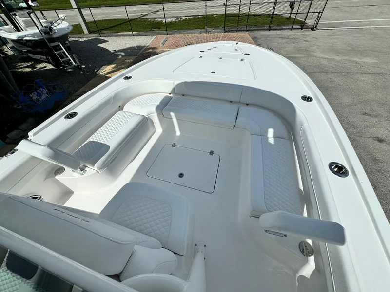 Slide: The Image of 2025 Caymas 281 HB boat interior with white seating and storage compartments. - 11