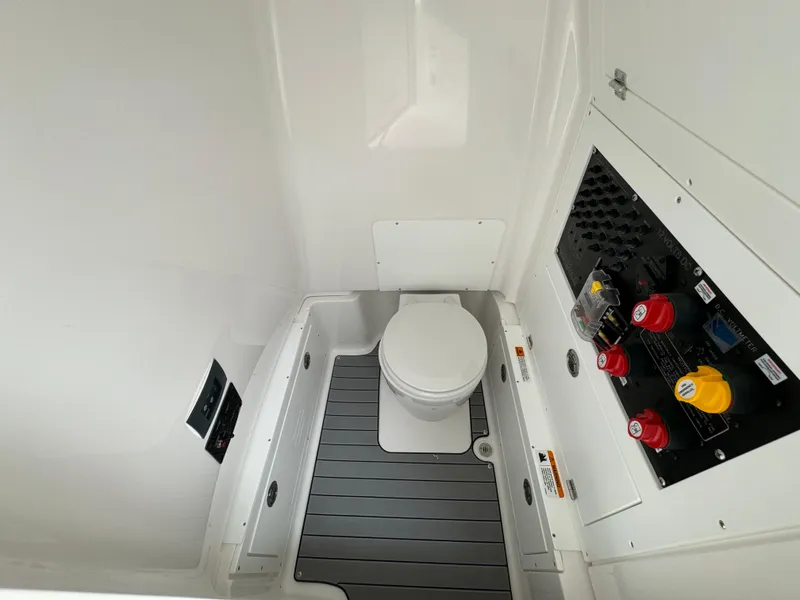 Slide: The Image of 2025 Caymas 281 HB boat interior with toilet and control panel. - 14