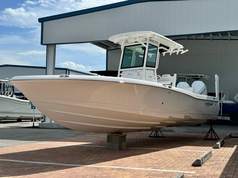 Slide: The Image of 2025 Caymas 281 HB boat displayed outdoors on a sunny day. - 2