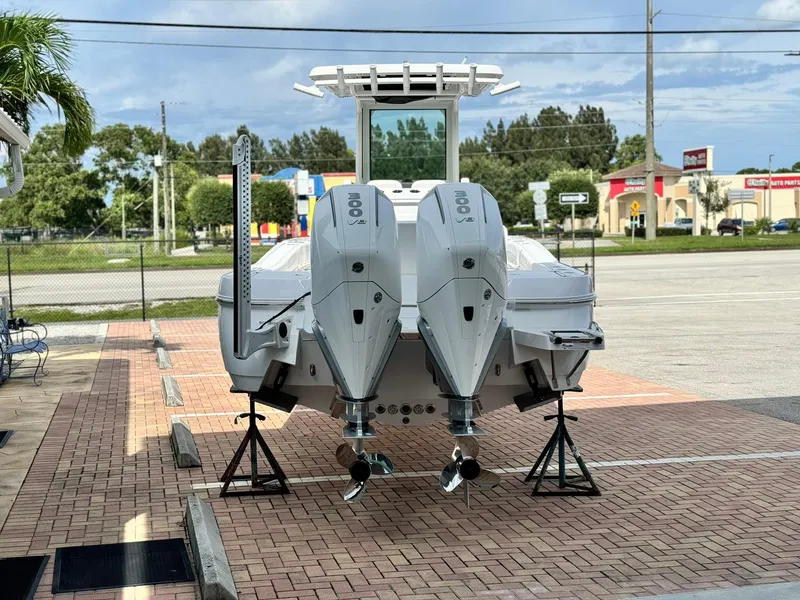 Slide: The Image of 2025 Caymas 281 HB boat with dual engines on display in a parking lot. - 3