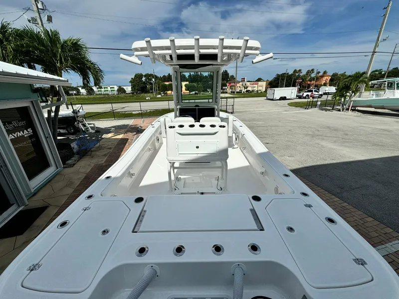 Slide: The Image of 2025 Caymas 281 HB boat, spacious deck, modern design, parked outdoors. - 4