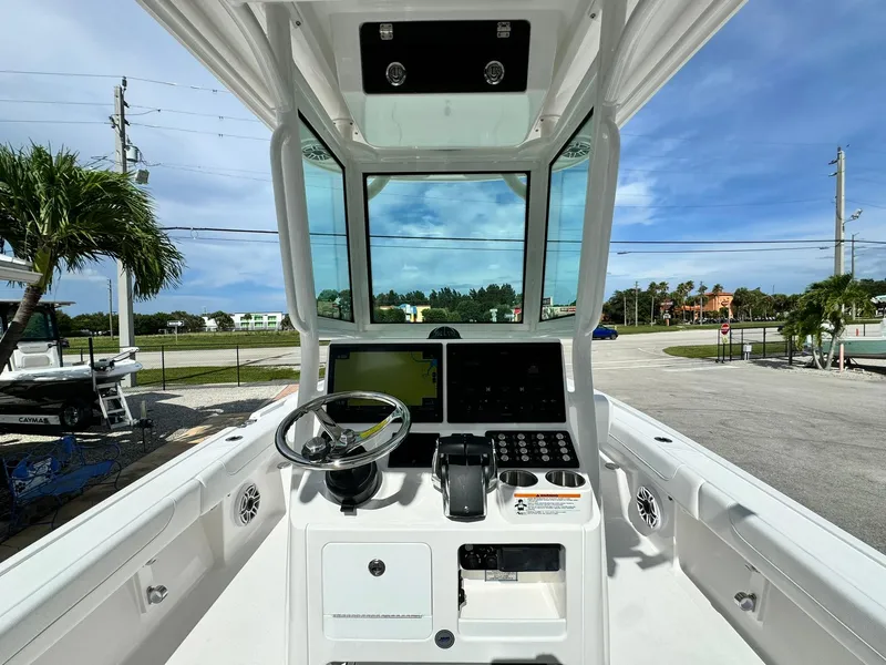 Slide: The Image of 2025 Caymas 281 HB boat cockpit with modern steering and navigation controls. - 8