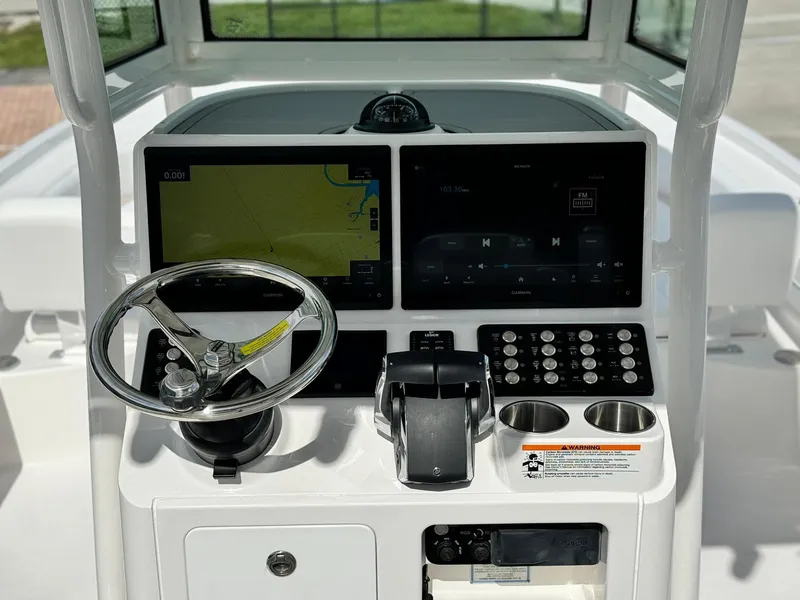 Slide: The Image of 2025 Caymas 281 HB boat dashboard with dual screens and steering wheel. - 9