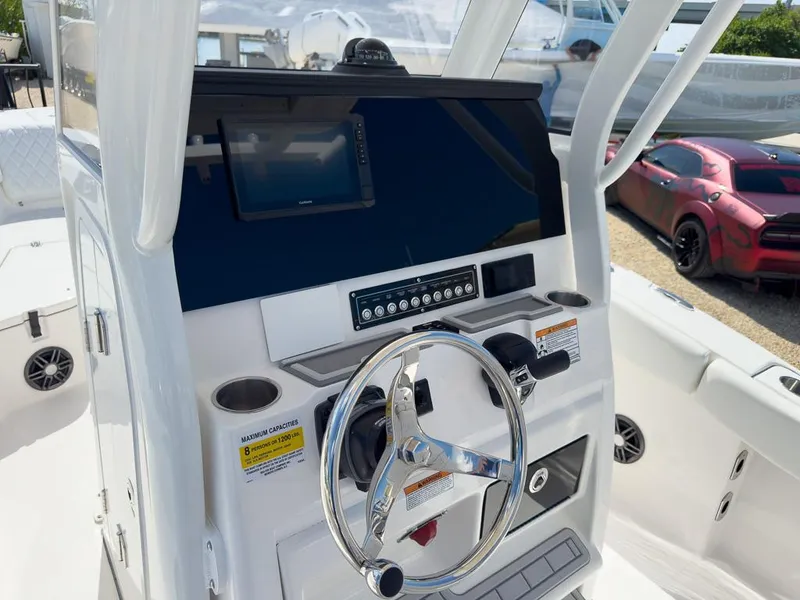 Slide: The Image of 2025 Sea Fox 228 Commander boat dashboard with steering wheel and navigation display. - 17