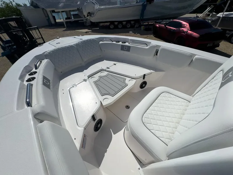 Slide: The Image of 2025 Sea Fox 228 Commander boat interior with white cushioned seating and storage compartments. - 19