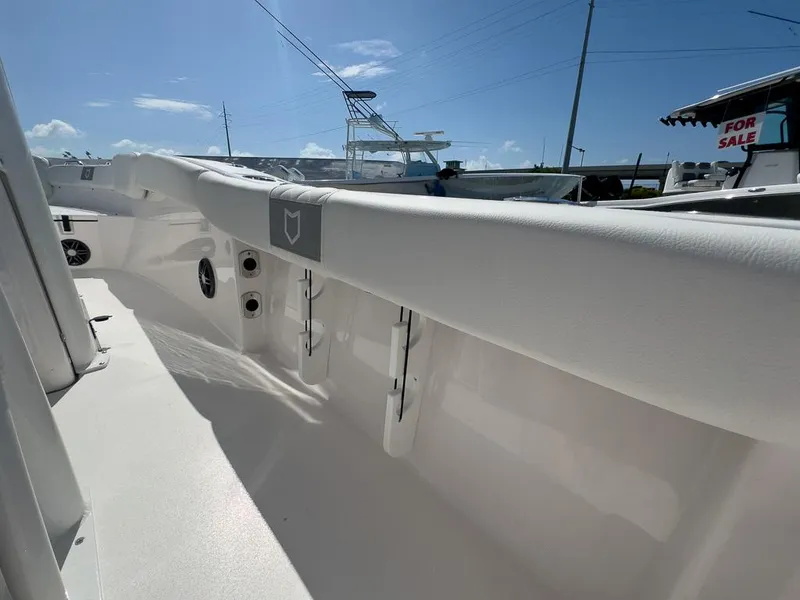 Slide: The Image of 2025 Sea Fox 228 Commander boat interior, white seating, sunny day, for sale sign visible. - 23