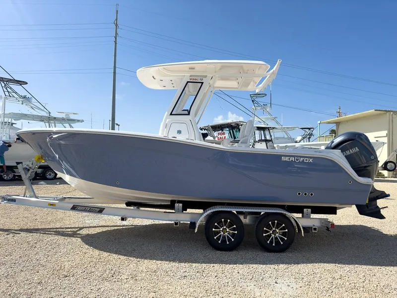 Slide: The Image of 2025 Sea Fox 228 Commander boat on trailer, side view, sunny day. - 6