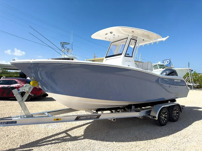 Slide: The Image of 2025 Sea Fox 228 Commander boat on trailer under clear blue sky. - 7