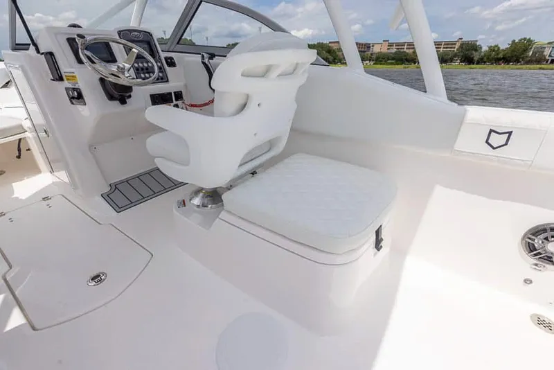 Slide: The Image of 2025 Sea Fox 228 Traveler boat interior with white seating and steering console. - 17
