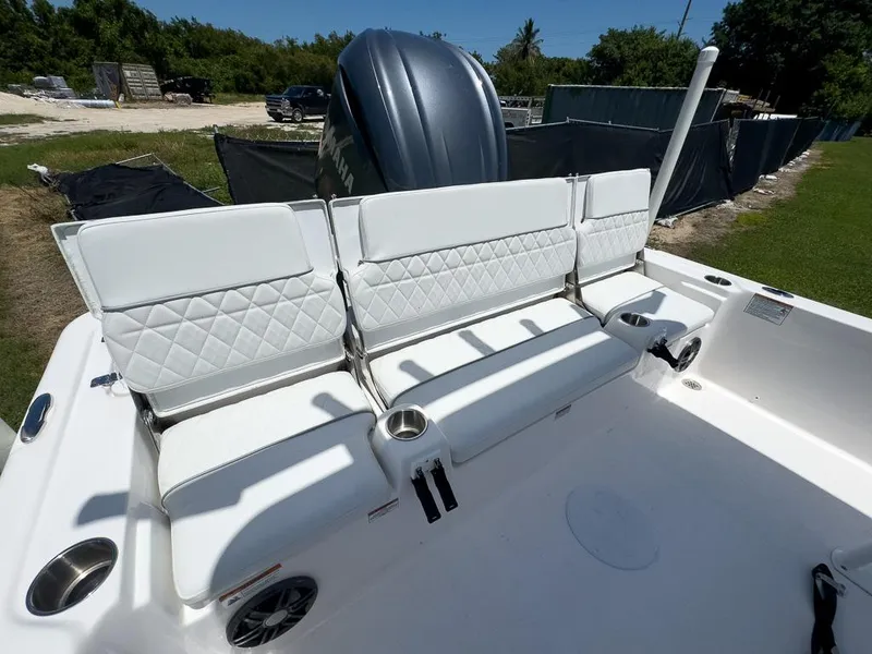 Slide: The Image of 2025 Sea Fox 231 Bay Fox boat with white cushioned seating and cup holders. - 14