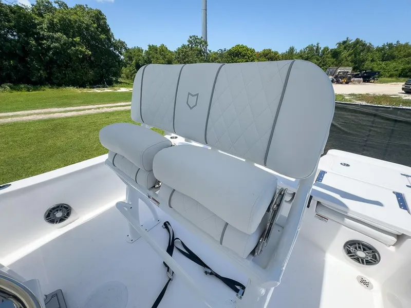 Slide: The Image of 2025 Sea Fox 231 Bay Fox boat with white cushioned seating, outdoors. - 19