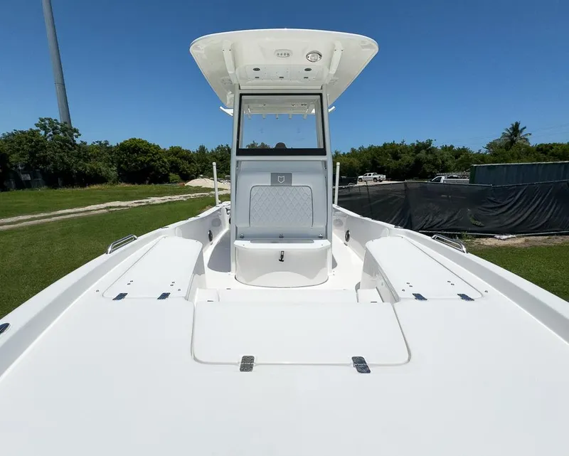 Slide: The Image of 2025 Sea Fox 231 Bay Fox boat, white deck, clear sky background. - 22
