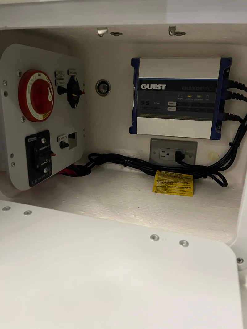 Slide: The Image of Electrical panel inside 2025 Defiance Admiral 220 EX boat, featuring Guest charger and wiring. - 8