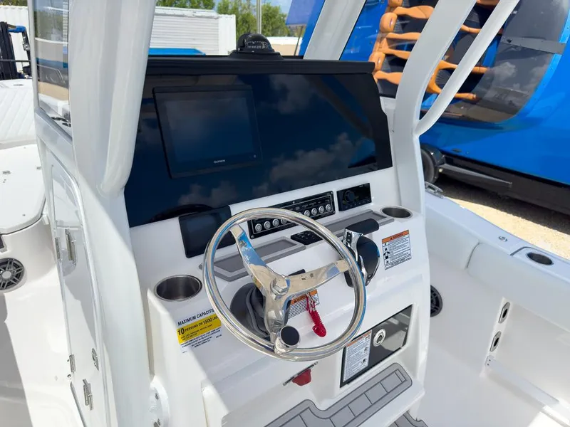 Slide: The Image of 2025 Sea Fox 248 Commander boat console with steering wheel and navigation display. - 13