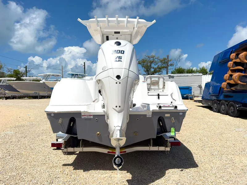 Slide: The Image of 2025 Sea Fox 248 Commander boat with powerful outboard motor, parked on gravel lot. - 3