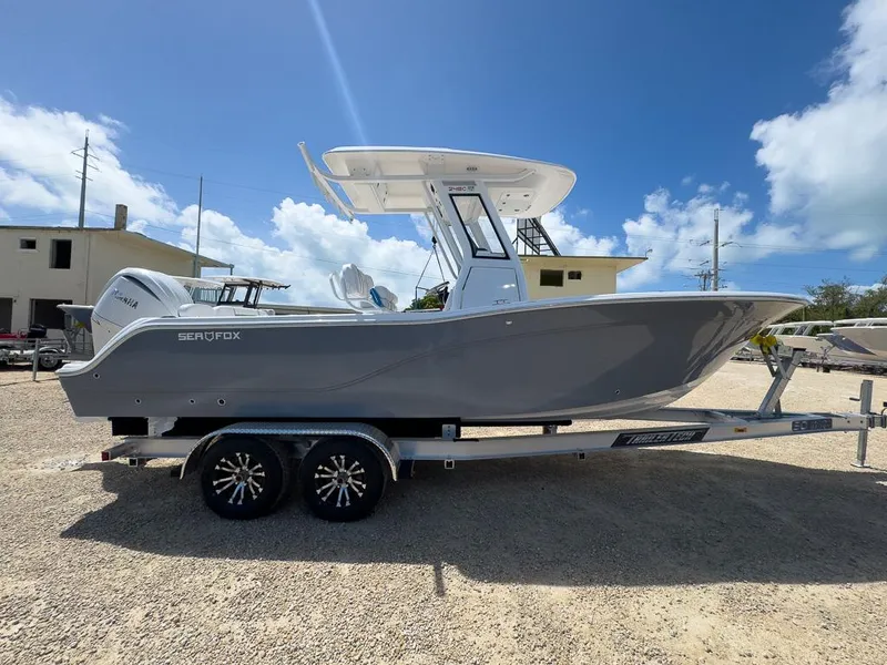 Slide: The Image of 2025 Sea Fox 248 Commander boat on trailer under clear blue sky. - 5
