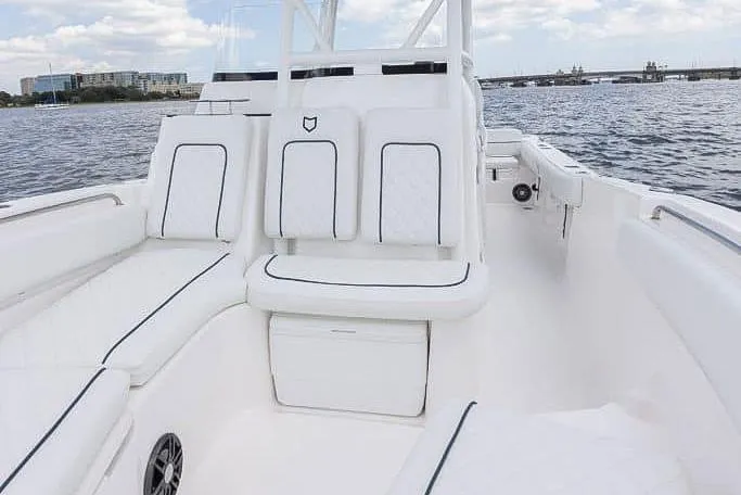Slide: The Image of 2025 Sea Fox 248 Side Console boat interior with white seating and ocean view. - 13