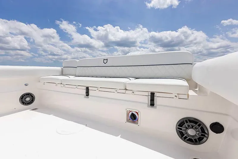 Slide: The Image of 2025 Sea Fox 248 Side Console boat seating under blue sky. - 20