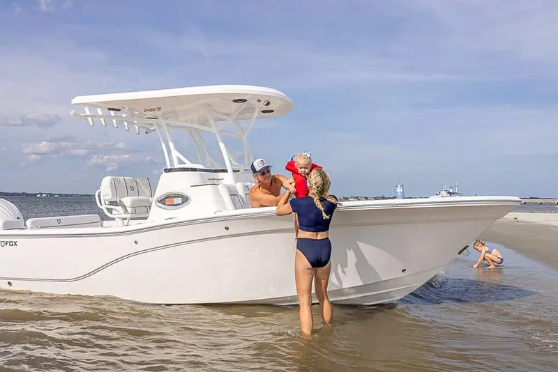 Slide: The Image of Family enjoying a day with 2025 Sea Fox 248 Side Console boat on the beach. - 7