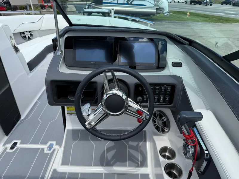 Slide: The Image of 2025 Regal LS4 boat dashboard with steering wheel, dual screens, and control panel. - 7