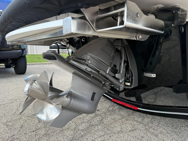 Slide: The Image of 2025 Regal LS4 boat with a stainless steel propeller and outdrive, parked on pavement. - 8
