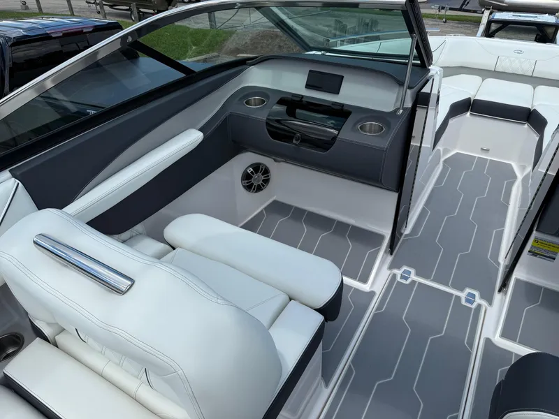 Slide: The Image of 2025 Regal LS4 boat interior with white seating, modern dashboard, and sleek flooring design. - 9