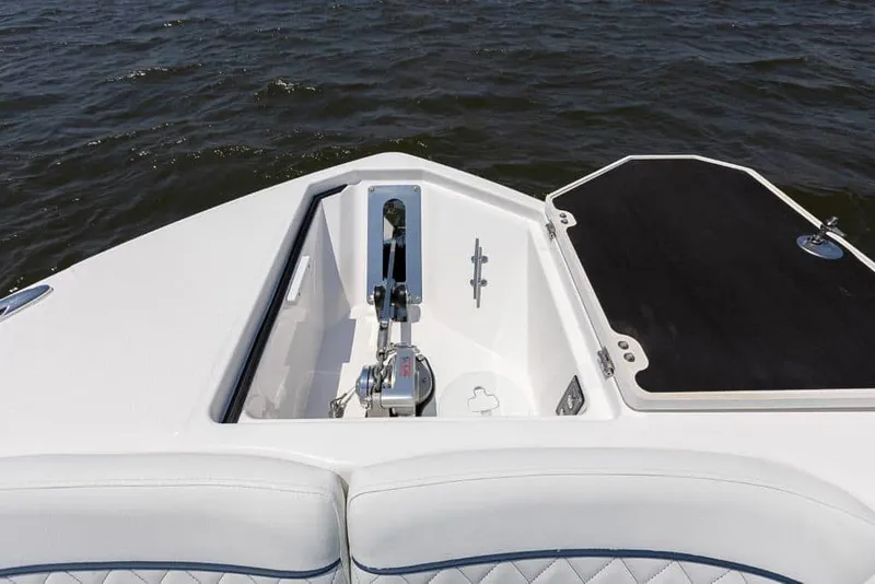 Slide: The Image of 2025 Sea Fox 268 Traveler boat bow with anchor compartment open on water. - 12