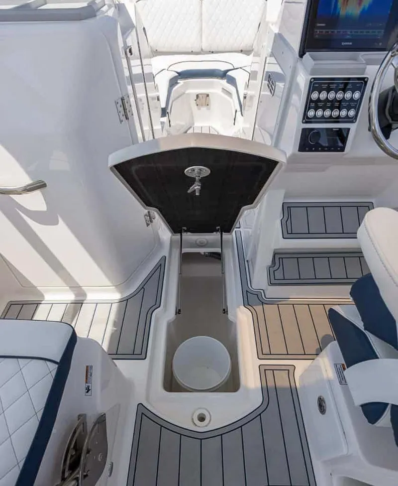 Slide: The Image of 2025 Sea Fox 268 Traveler boat interior with open storage compartment and modern dashboard. - 18