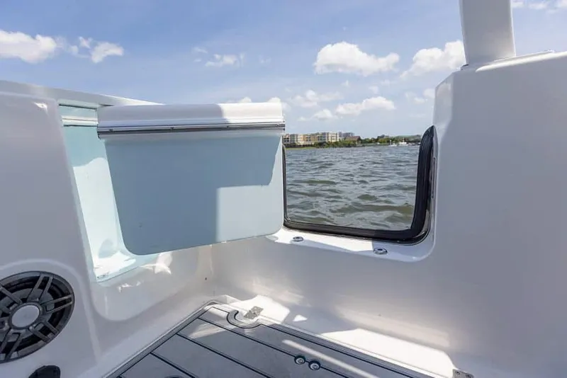Slide: The Image of 2025 Sea Fox 268 Traveler boat interior with open hatch, overlooking water and sky. - 24